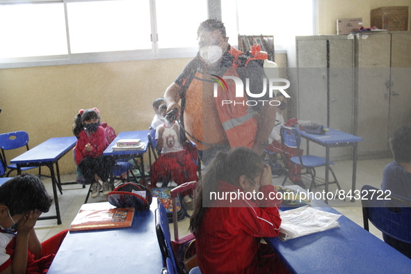 Civil Protection workers spread disinfectant inside class rooms of a primary school  to avoid new Covid-19 infections after an increase of C...