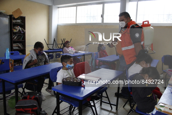 Civil Protection workers spread disinfectant inside class rooms of a primary school  to avoid new Covid-19 infections after an increase of C...