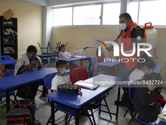 Civil Protection workers spread disinfectant inside class rooms of a primary school  to avoid new Covid-19 infections after an increase of C...