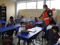 Civil Protection workers spread disinfectant inside class rooms of a primary school  to avoid new Covid-19 infections after an increase of C...