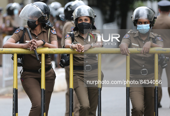 Female police members stand guard while, Samagi Vanitha Balawegaya protests near Sri Lanka's Prime Minister Ranil Wickremesinghe's private r...