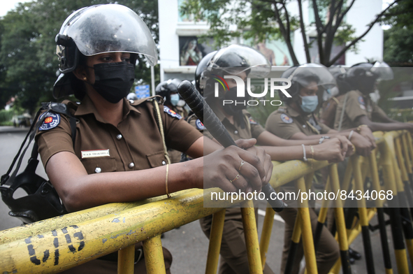 Female police members stand guard while, Samagi Vanitha Balawegaya protests near Sri Lanka's Prime Minister Ranil Wickremesinghe's private r...