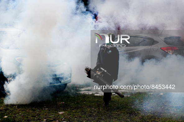 A health worker fumigates to kill mosquito larvae to fight against the spread of dengue fever in Bogor, West Java, Indonesia on June 26, 202...