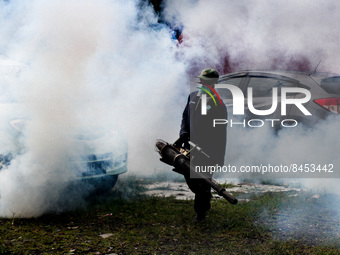 A health worker fumigates to kill mosquito larvae to fight against the spread of dengue fever in Bogor, West Java, Indonesia on June 26, 202...