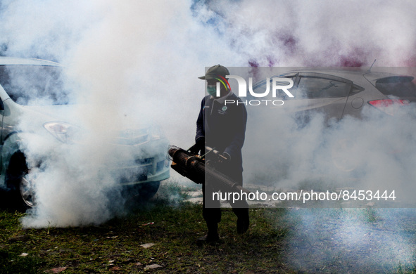 A health worker fumigates to kill mosquito larvae to fight against the spread of dengue fever in Bogor, West Java, Indonesia on June 26, 202...