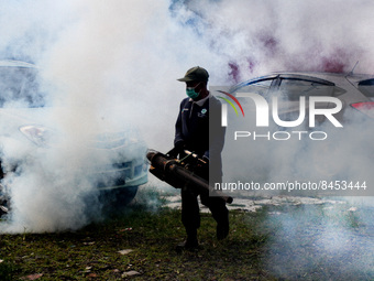 A health worker fumigates to kill mosquito larvae to fight against the spread of dengue fever in Bogor, West Java, Indonesia on June 26, 202...