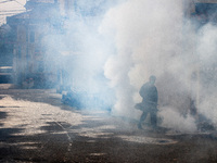 A health worker fumigates to kill mosquito larvae to fight against the spread of dengue fever in Bogor, West Java, Indonesia on June 26, 202...