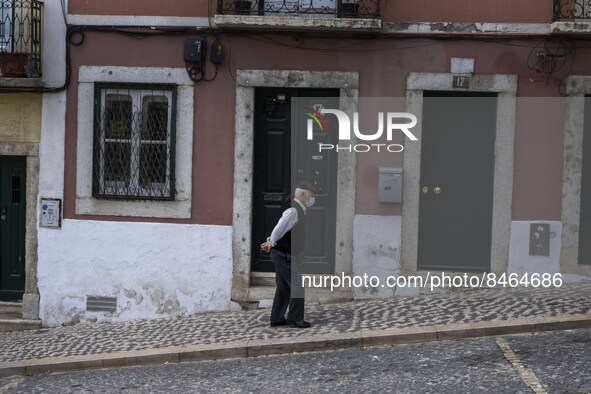 A man wearing a protective mask is seen walking down one of the streets of the Graça neighborhood. Lisbon, June 24, 2022. In Portugal, covid...