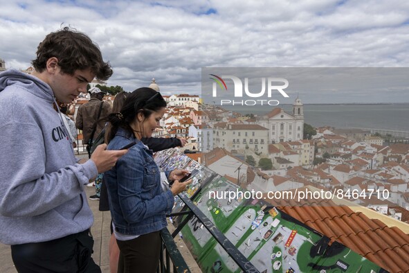 Tourists are seen observing the historic center of the city from the São Vicente viewpoint. Lisbon, June 24, 2022. In Portugal, covid-19 mor...