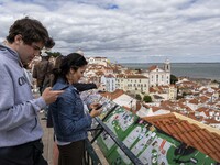 Tourists are seen observing the historic center of the city from the São Vicente viewpoint. Lisbon, June 24, 2022. In Portugal, covid-19 mor...