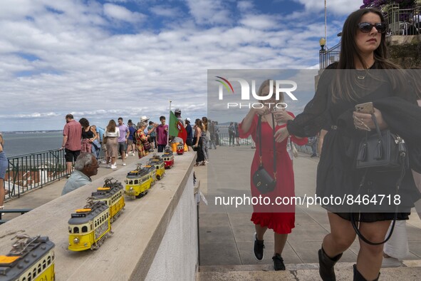 Tourists are seen observing the historic center of the city from Das Portas do Sol viewpoint. Lisbon, June 24, 2022.  