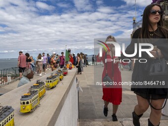 Tourists are seen observing the historic center of the city from Das Portas do Sol viewpoint. Lisbon, June 24, 2022.  (