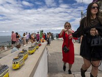 Tourists are seen observing the historic center of the city from Das Portas do Sol viewpoint. Lisbon, June 24, 2022.  (