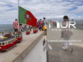 Tourists are seen observing the historic center of the city from Das Portas do Sol viewpoint. Lisbon, June 24, 2022. In Portugal, covid-19 m...