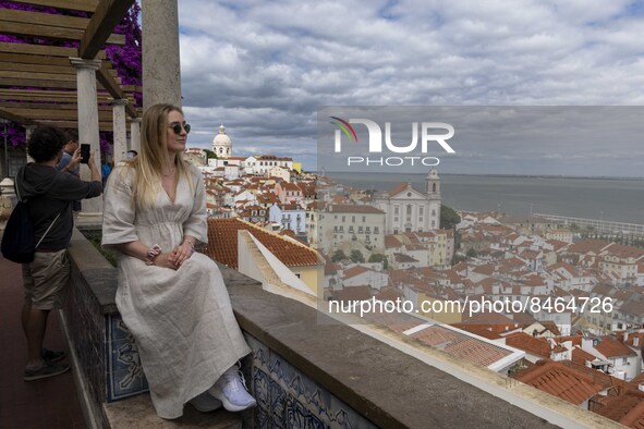 Tourists are seen observing the historic center of the city from Santa Luzia viewpoint. Lisbon, June 24, 2022. In Portugal, covid-19 mortali...