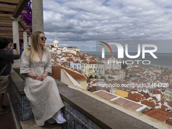 Tourists are seen observing the historic center of the city from Santa Luzia viewpoint. Lisbon, June 24, 2022. In Portugal, covid-19 mortali...