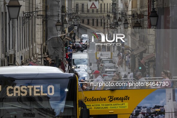 People are seen traveling through the streets of Baixa in a tourist transport bus. Lisbon, June 24, 2022. In Portugal, covid-19 mortality is...