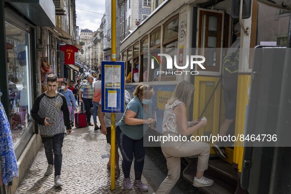 People are seen boarding a tram in the Baixa district. Lisbon, June 24, 2022. In Portugal, covid-19 mortality is declining, although it is s...