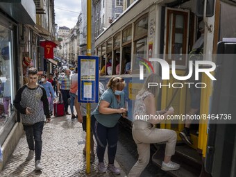 People are seen boarding a tram in the Baixa district. Lisbon, June 24, 2022. In Portugal, covid-19 mortality is declining, although it is s...