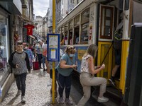 People are seen boarding a tram in the Baixa district. Lisbon, June 24, 2022. In Portugal, covid-19 mortality is declining, although it is s...