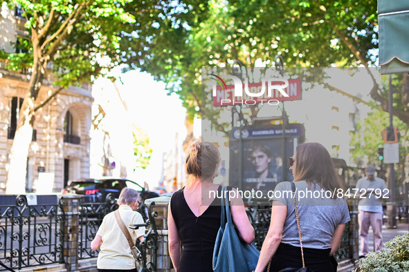 Women pass by the metro station. Daily life in Parisian metro, as France faces an increase of Covid19 cases. . 