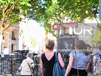 Women pass by the metro station. Daily life in Parisian metro, as France faces an increase of Covid19 cases. . (