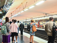 People waiting for the metro on the platform. Daily life in Parisian metro, as France faces an increase of Covid19 cases. . (