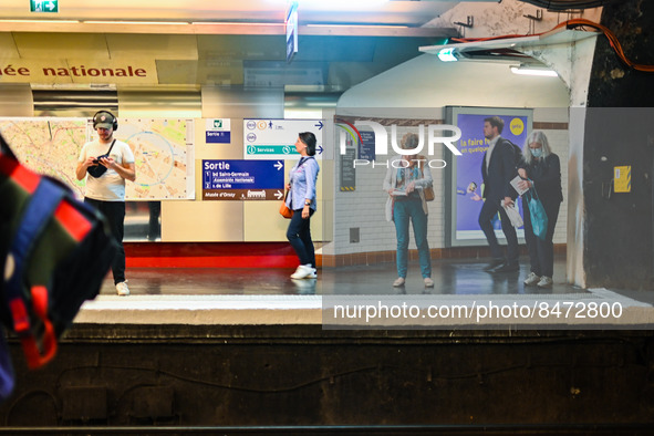 People waiting for the metro on the platform. Daily life in Parisian metro, as France faces an increase of Covid19 cases. . 