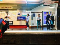 People waiting for the metro on the platform. Daily life in Parisian metro, as France faces an increase of Covid19 cases. . (