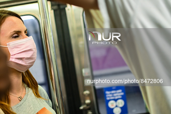 A woman wears a face mask in the metro, as the Minister of Health Brigitte Bourguignon recommended to wear one on public transports. Daily l...