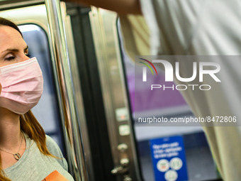 A woman wears a face mask in the metro, as the Minister of Health Brigitte Bourguignon recommended to wear one on public transports. Daily l...