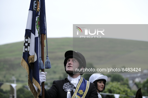 Galashiels, UK. 02 Jul.2022.  
Braw Lad John Turnbull carries the Burgh Flag on horse back , ready to lead the ceremonial rideout.

GALASHIE...