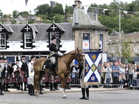 Galashiels, UK. 02 Jul.2022.  
Braw Lad arrives at War Memorial behind Pipe Band.
before the dipping of the Burgh Flag in front of the War M...