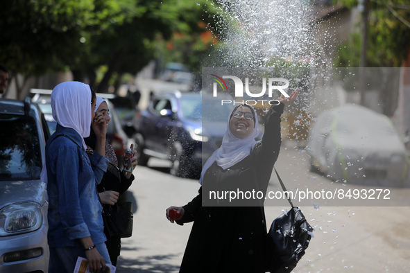 Palestinian students celebrate the last day in their final high school exams, known as ''Tawjihi'', in Gaza city on July 04, 2022.  