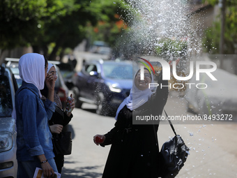 Palestinian students celebrate the last day in their final high school exams, known as ''Tawjihi'', in Gaza city on July 04, 2022.  (