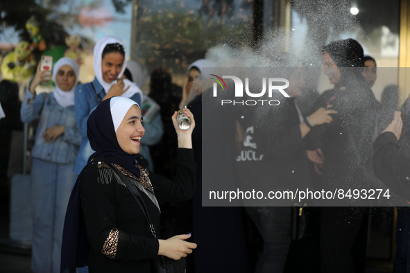 Palestinian students celebrate the last day in their final high school exams, known as ''Tawjihi'', in Gaza city on July 04, 2022.  