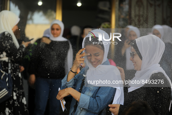 Palestinian students celebrate the last day in their final high school exams, known as ''Tawjihi'', in Gaza city on July 04, 2022.  