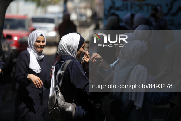 Palestinian students celebrate the last day in their final high school exams, known as ''Tawjihi'', in Gaza city on July 04, 2022.  