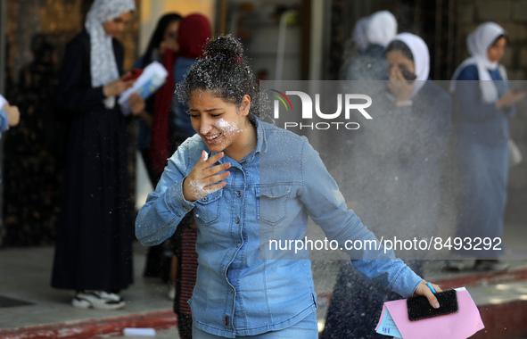 Palestinian students celebrate the last day in their final high school exams, known as ''Tawjihi'', in Gaza city on July 04, 2022.  