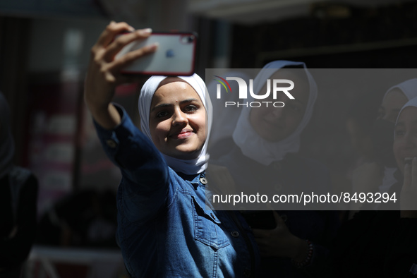 Palestinian students celebrate the last day in their final high school exams, known as ''Tawjihi'', in Gaza city on July 04, 2022.  