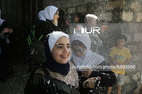 Palestinian students celebrate the last day in their final high school exams, known as ''Tawjihi'', in Gaza city on July 04, 2022.  