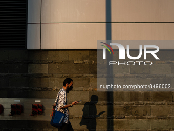 A man wear protective face masks while walking at pedestrian in Jakarta on 5 July 2022. The Indonesian government on Tuesday, July 5, raised...