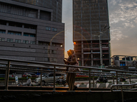 A woman wear protective face masks while walking at pedestrian in Jakarta on 5 July 2022. The Indonesian government on Tuesday, July 5, rais...