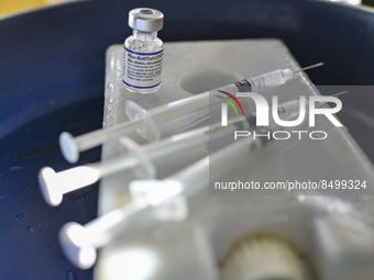 A health worker prepares a Booster Dose of the Pfizer vaccine during vaccination campaign outside of the cattle market at Daulatkhan, Bhola,...