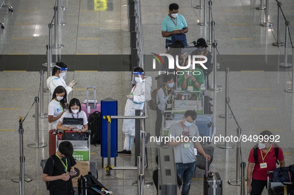 Travellers waiting in line for shuttle bus to quarantine hotels inside Hong Kong International Airport on July 7, 2022 in Hong Kong, China....