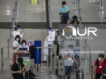 Travellers waiting in line for shuttle bus to quarantine hotels inside Hong Kong International Airport on July 7, 2022 in Hong Kong, China....