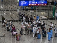 Travellers waiting in line for shuttle bus to quarantine hotels inside Hong Kong International Airport on July 7, 2022 in Hong Kong, China....