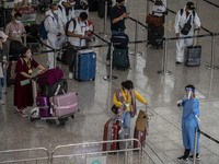 Travellers waiting in line for shuttle bus to quarantine hotels inside Hong Kong International Airport on July 7, 2022 in Hong Kong, China....