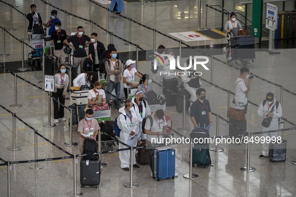 Travellers waiting in line for shuttle bus to quarantine hotels inside Hong Kong International Airport on July 7, 2022 in Hong Kong, China....