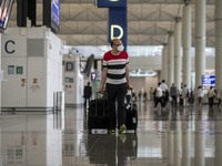 A Man pulling two luggage bag inside Hong Kong International Airport on July 7, 2022 in Hong Kong, China. The Hong Kong Government announce...